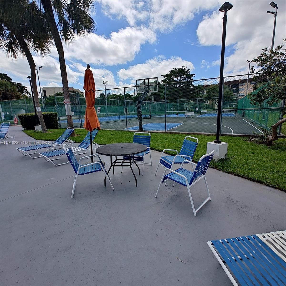 7051 Environ Boulevard, Unit 433 Lauderhill, FL 33319 - Photo 34 of 36 a swimming pool with outdoor seating and yard