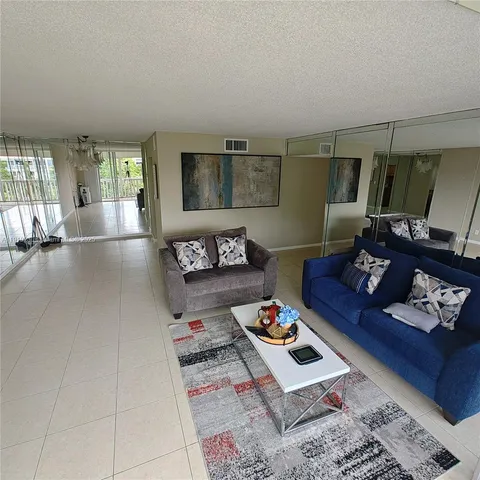 a living room with hard wood flooring and a couch