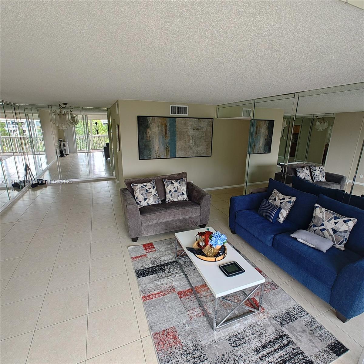 7051 Environ Boulevard, Unit 433 Lauderhill, FL 33319 - Photo 10 of 36 a living room with furniture and wooden floor