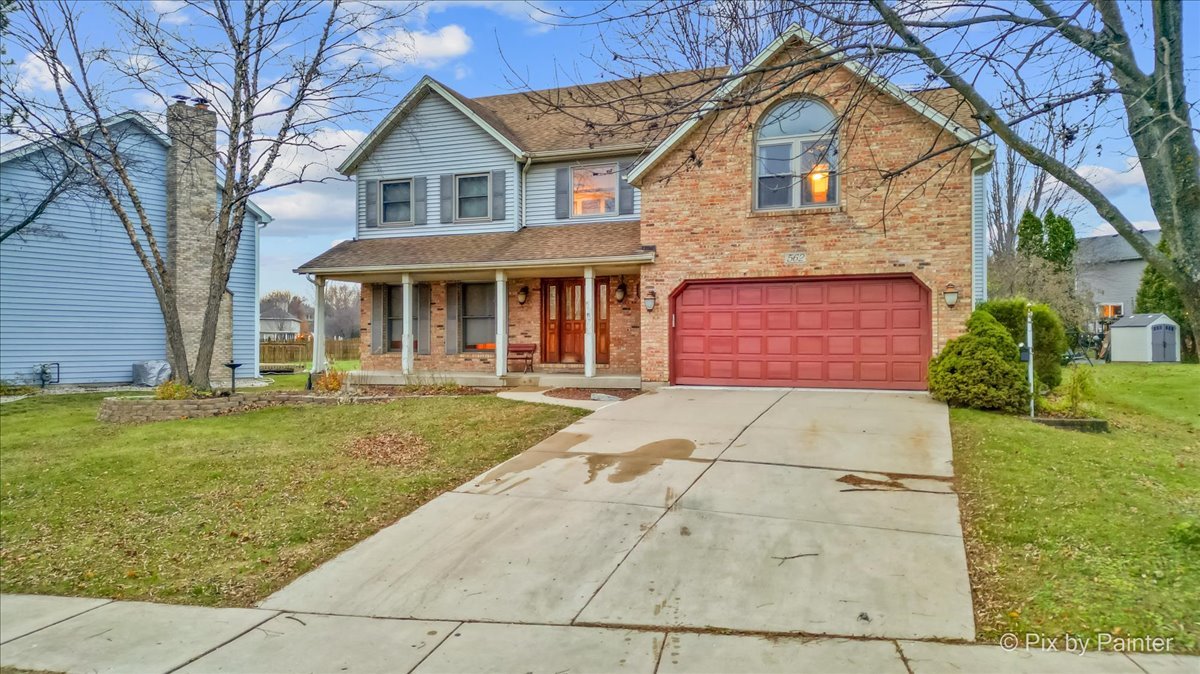562 Boardman Circle Bolingbrook, IL 60440 - Photo 2 of 47 a front view of a house with a yard