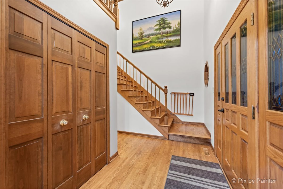 562 Boardman Circle Bolingbrook, IL 60440 - Photo 3 of 47 a view of a hallway with wooden floor and staircase