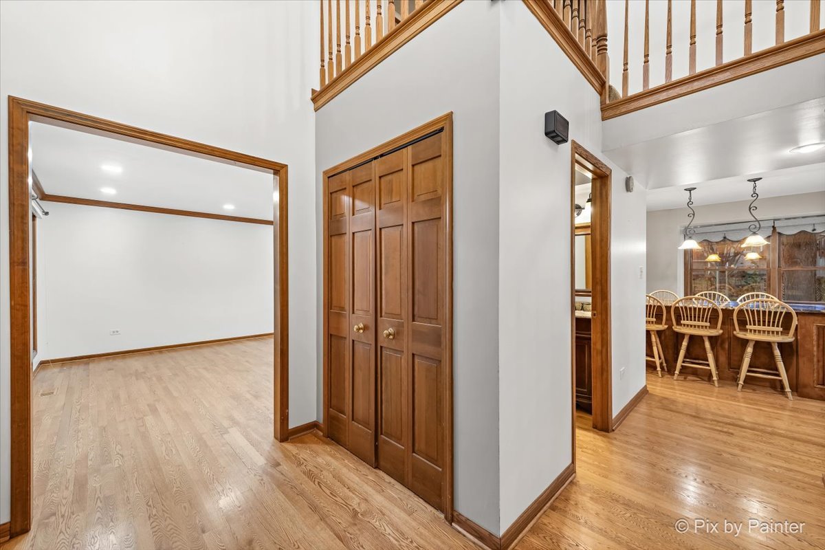 562 Boardman Circle Bolingbrook, IL 60440 - Photo 4 of 47 a view of a hallway with wooden floor and dining room