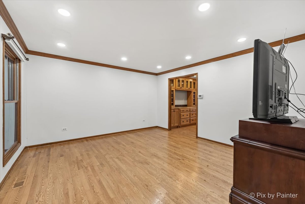 562 Boardman Circle Bolingbrook, IL 60440 - Photo 8 of 47 a view of an empty room with wooden floor