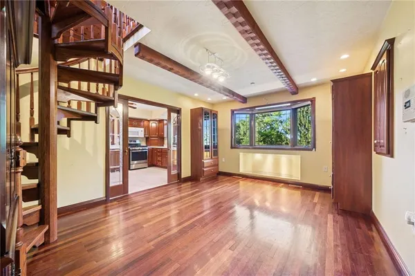 a view of an entryway with wooden floor and door