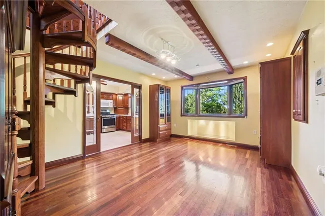 a view of an entryway with wooden floor and door