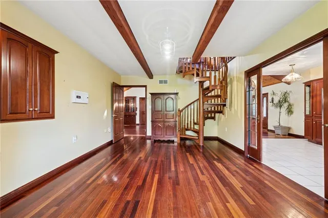 a view of entryway with wooden floor and stairs