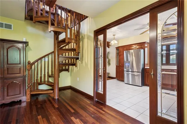 a view of entryway and hall with wooden floor
