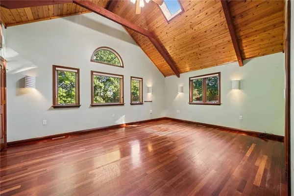 a view of a room with wooden floor and window