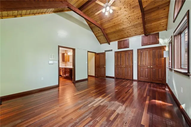 a spacious bathroom with a granite countertop sink and a mirror