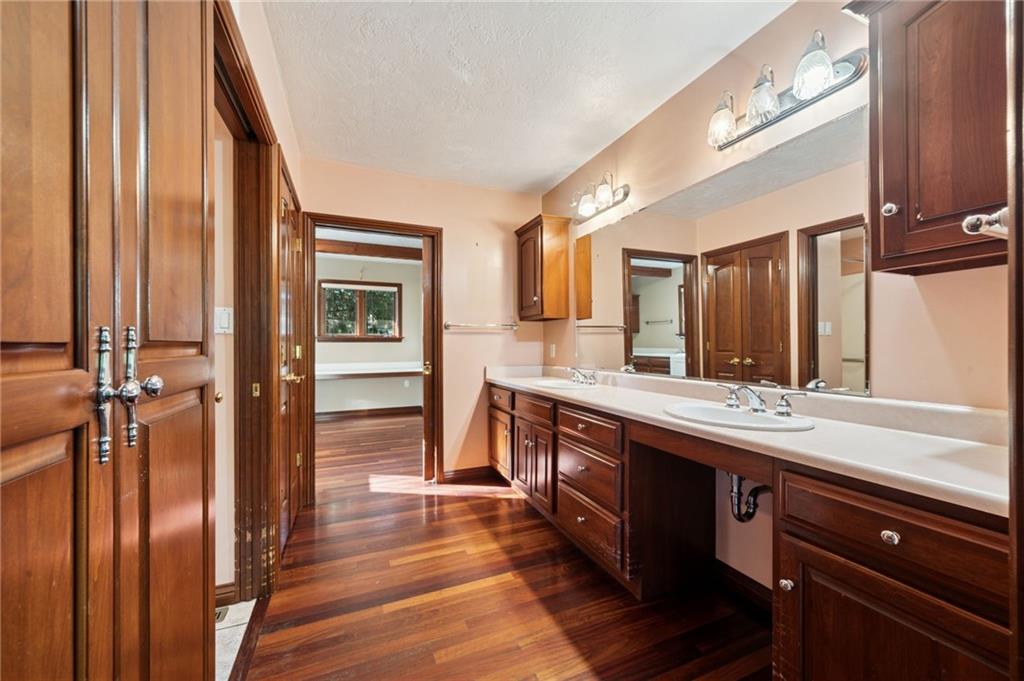260 Jennie Drive Irwin, PA 15642 - Photo 25 of 49 a spacious bathroom with a granite countertop sink and a mirror