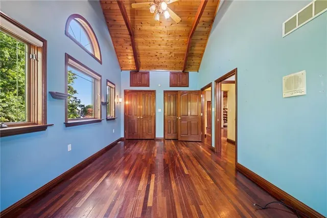 a view of a hallway with entryway wooden floor and front door