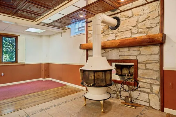 a view of an empty room with window and cabinet