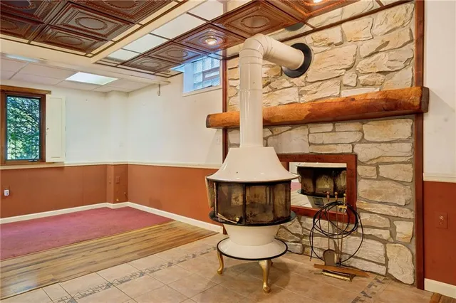 a view of an empty room with window and cabinet