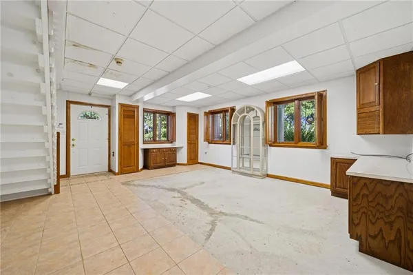 a view of a house with a yard and potted plants