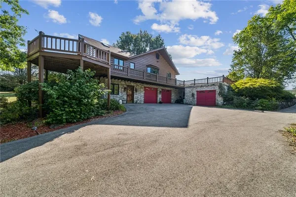 an aerial view of a house with a yard basket ball court and outdoor seating