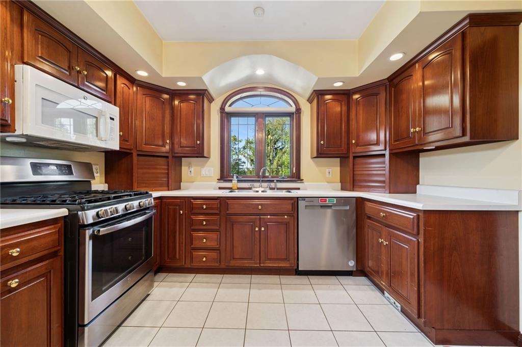 260 Jennie Drive Irwin, PA 15642 - Photo 7 of 49 a kitchen with stainless steel appliances granite countertop a stove a sink and a microwave