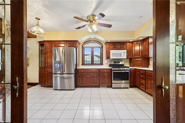 a kitchen with a stove a refrigerator and a sink