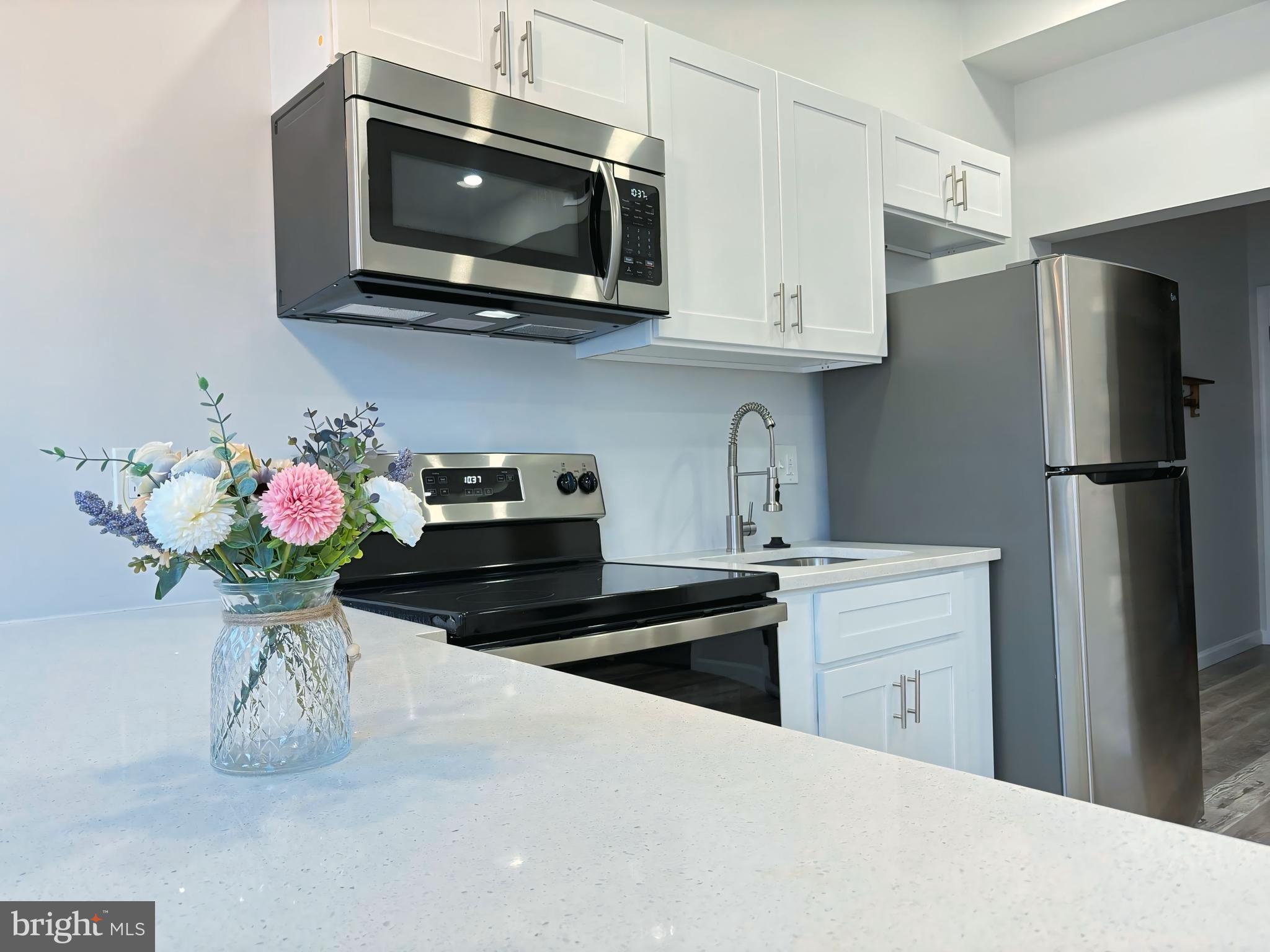 2023 McCulloh Street, Unit 2 Baltimore, MD 21217 - Photo 1 of 1 a kitchen with stainless steel appliances granite countertop a sink a microwave a refrigerator and cabinets