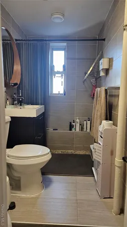 a bathroom with a sink toilet and mirror