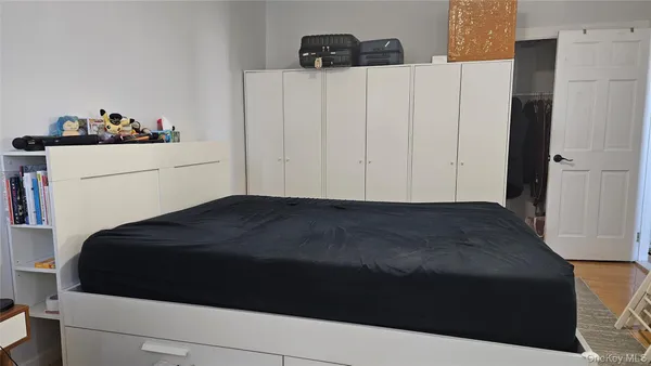 a bedroom with a bed and cabinets