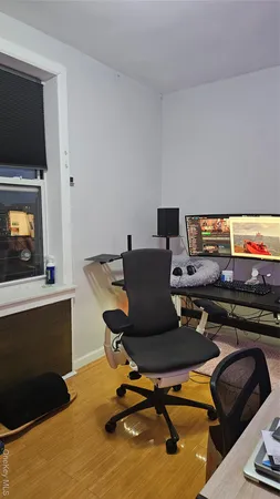 a view of a workspace with furniture and a fireplace