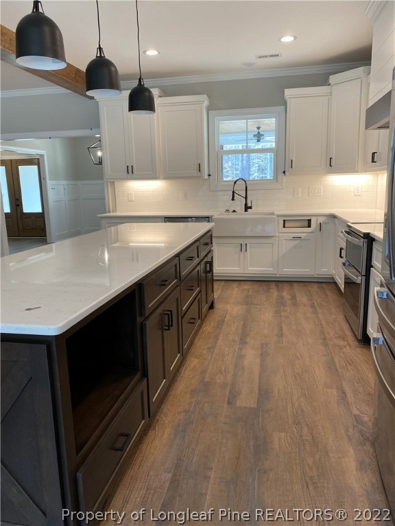 3900 Gainey Road Fayetteville, NC 28306 - Photo 4 of 9 a kitchen with stainless steel appliances granite countertop a sink a stove top oven a counter space and cabinets