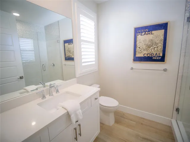 a view of a big room with a table and chairs