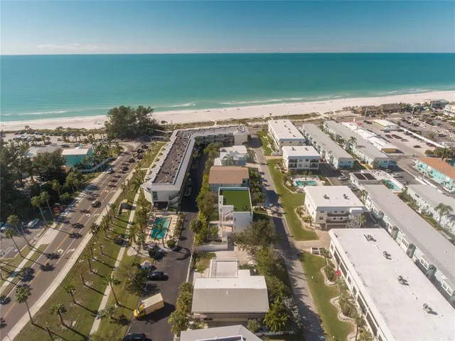 an aerial view of residential houses with outdoor space