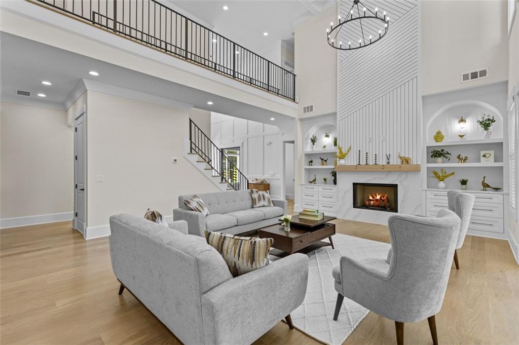 5 Olevia Street Winder, GA 30680 - Photo 16 of 106 a living room with furniture a fireplace and a chandelier