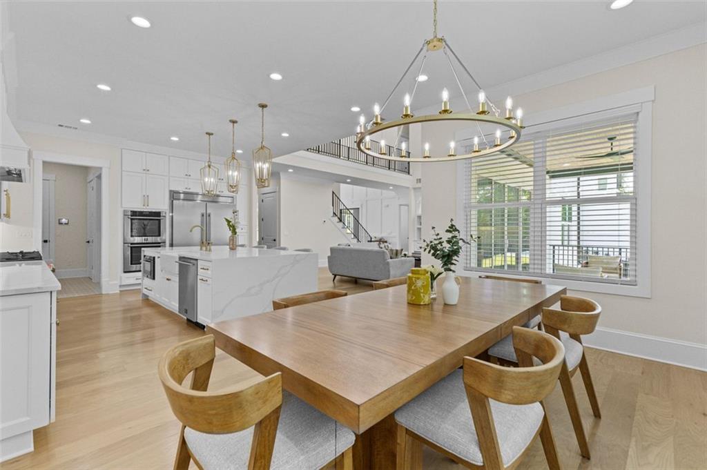 5 Olevia Street Winder, GA 30680 - Photo 35 of 106 a view of a dining room and livingroom with furniture wooden floor a chandelier