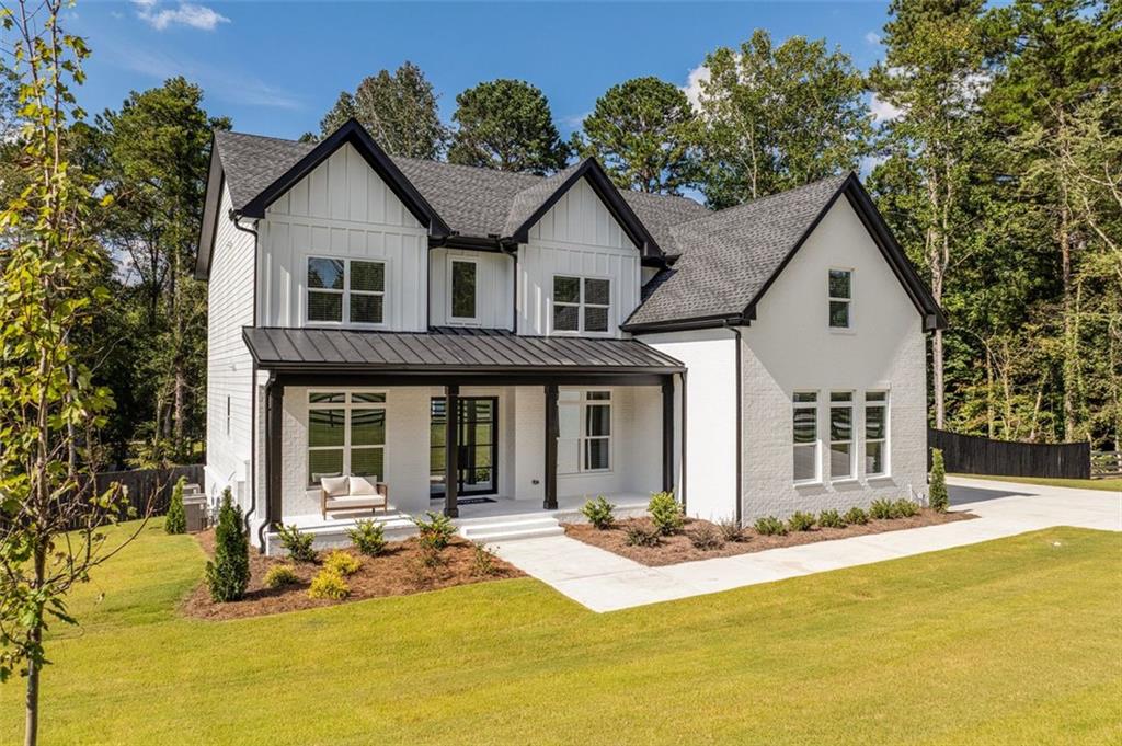 5 Olevia Street Winder, GA 30680 - Photo 4 of 106 a front view of house with yard and trees in the background