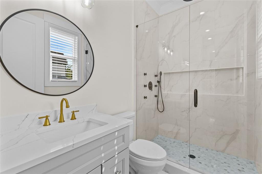 5 Olevia Street Winder, GA 30680 - Photo 41 of 106 a bathroom with a sink a toilet and a mirror