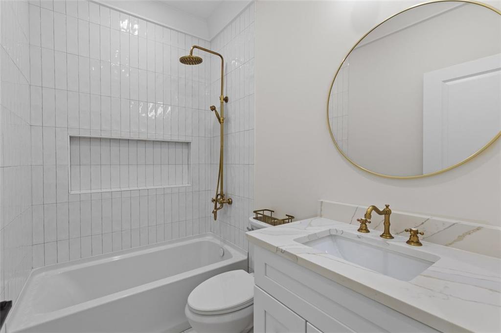 5 Olevia Street Winder, GA 30680 - Photo 59 of 106 a bathroom with a granite countertop sink a toilet and shower