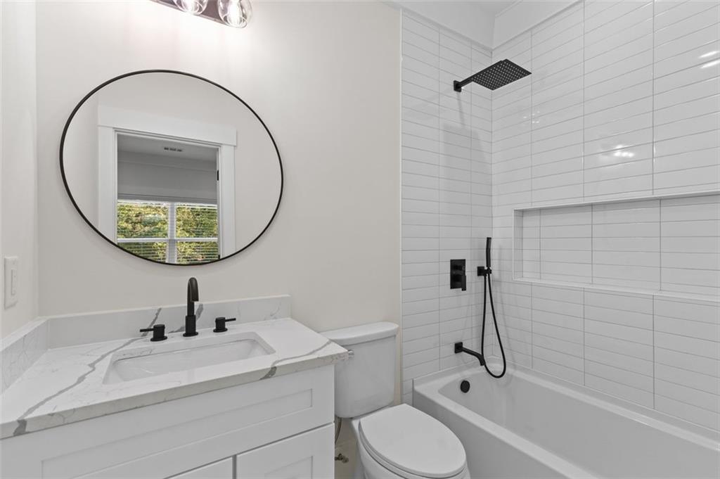 5 Olevia Street Winder, GA 30680 - Photo 62 of 106 a bathroom with a sink a toilet and a mirror