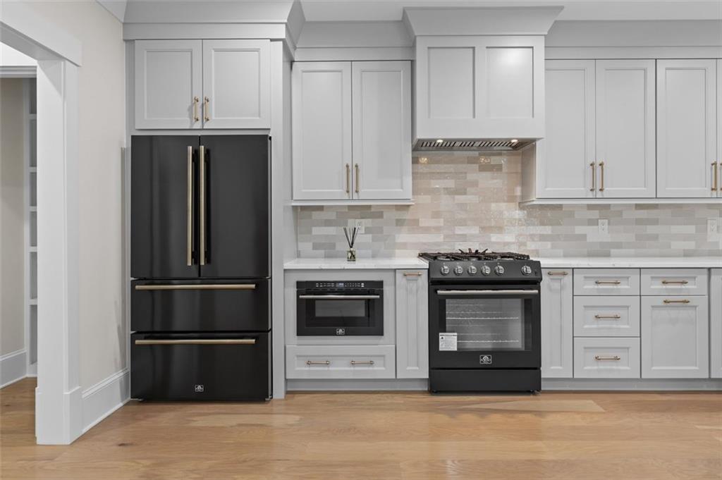 5 Olevia Street Winder, GA 30680 - Photo 66 of 106 a kitchen with stainless steel appliances white cabinets and a refrigerator