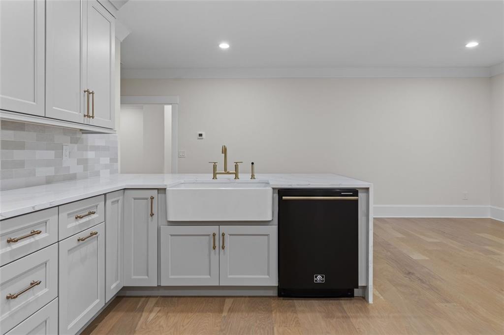 5 Olevia Street Winder, GA 30680 - Photo 67 of 106 a kitchen with white cabinets and sink