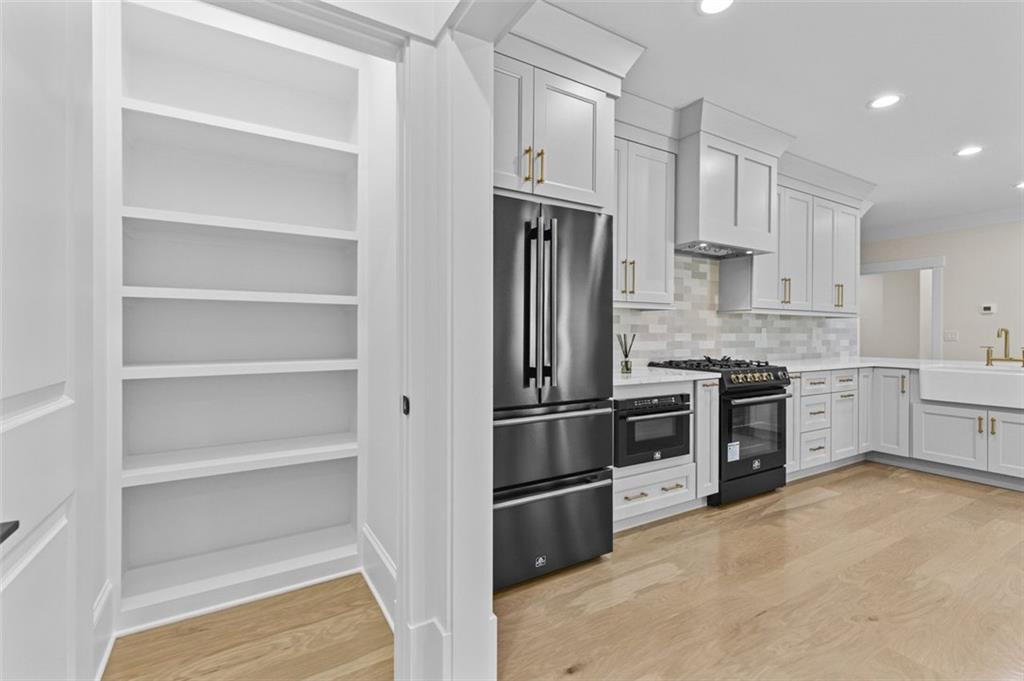 5 Olevia Street Winder, GA 30680 - Photo 68 of 106 a kitchen with cabinets stainless steel appliances and a window