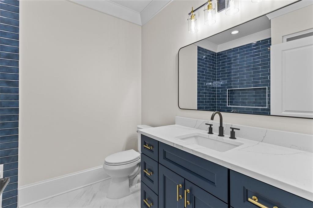 5 Olevia Street Winder, GA 30680 - Photo 79 of 106 a bathroom with a toilet a sink and mirror