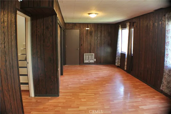 a view of an empty room with wooden door