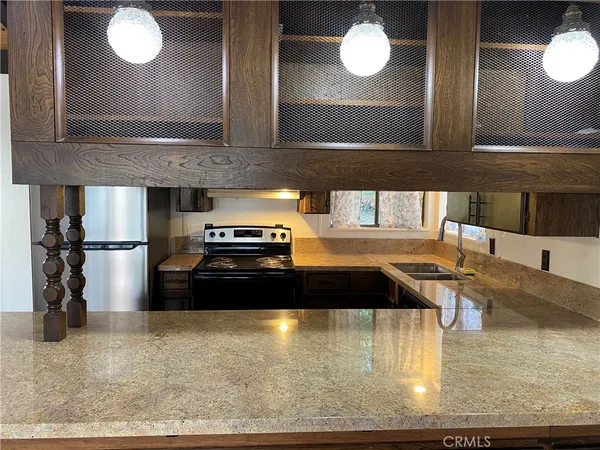 a kitchen with a refrigerator and a sink