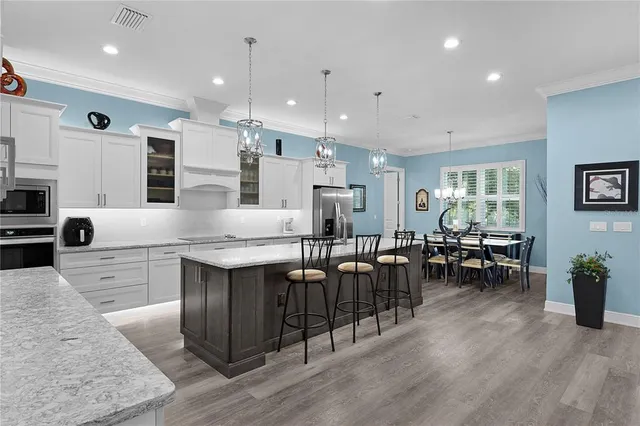 a kitchen with granite countertop a sink stove and cabinets