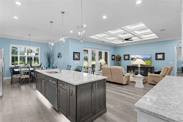 a view of a patio with table and chairs potted plants and a palm tree