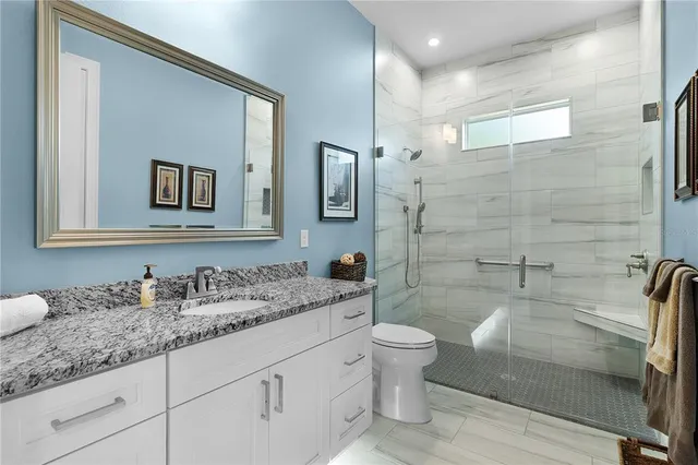 an aerial view of residential houses with outdoor space and trees