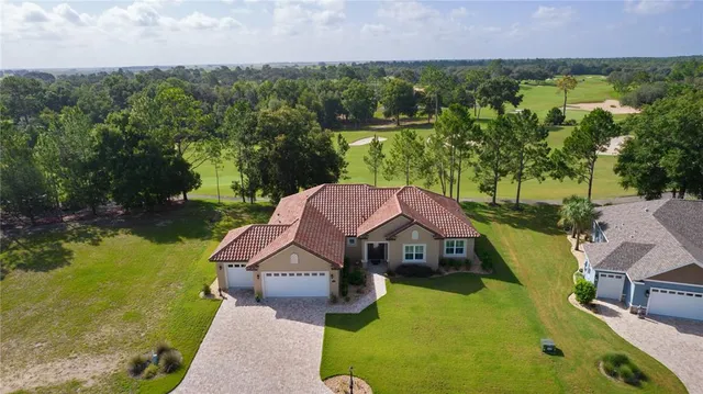 an aerial view of a house with swimming pool and garden