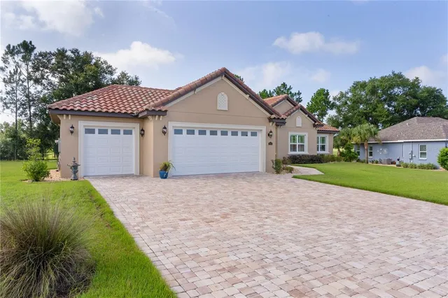 an aerial view of lake residential house with outdoor space and trees all around