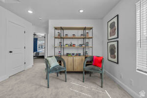 907 West Bright Ridge Ln Street, Unit 1430 St. George, UT 84790 - Photo 10 of 19 Carpeted room featuring a built-in shelving unit with lower wood-finish cabinetry, recessed lighting, and a window with blinds