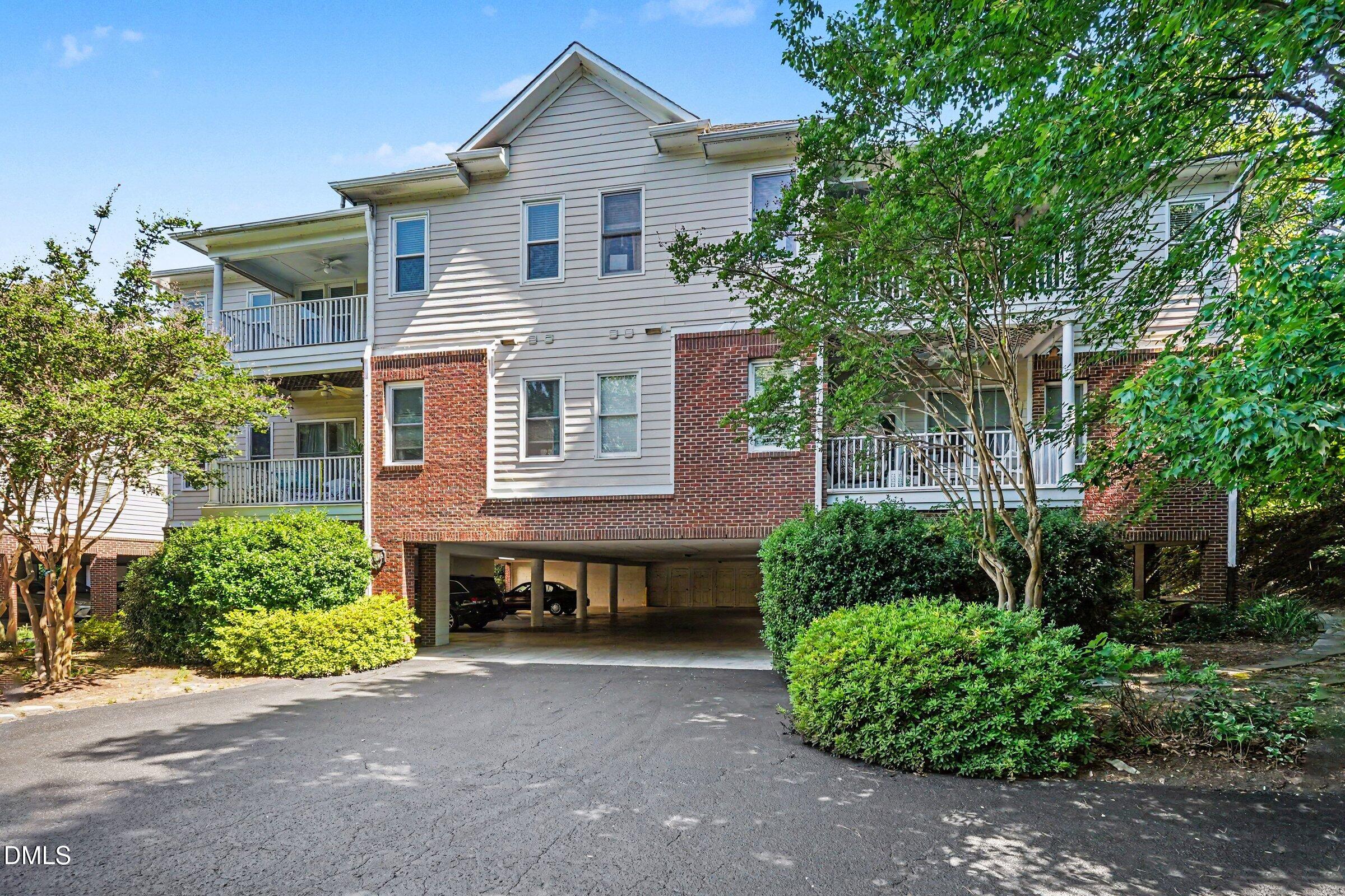 2651 Mellowfield Drive, Unit 203 Raleigh, NC 27604 - Photo 1 of 32 a front view of a house with a yard and potted plants