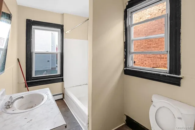 a bathroom with a sink a toilet and a mirror