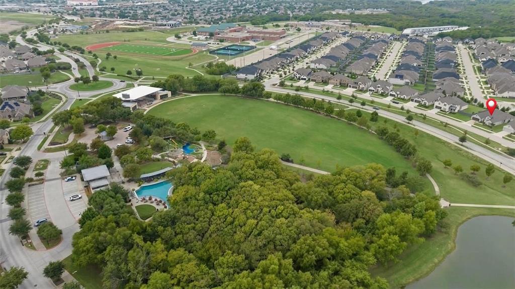 4933 Switchback Street Little Elm, TX 76227 - Photo 3 of 33 Aerial view of the home marked by the pin and showcasing the gorgeous green space in front including park, space, green belt, lawn, community pond, resort style pool, playground and pavillion.