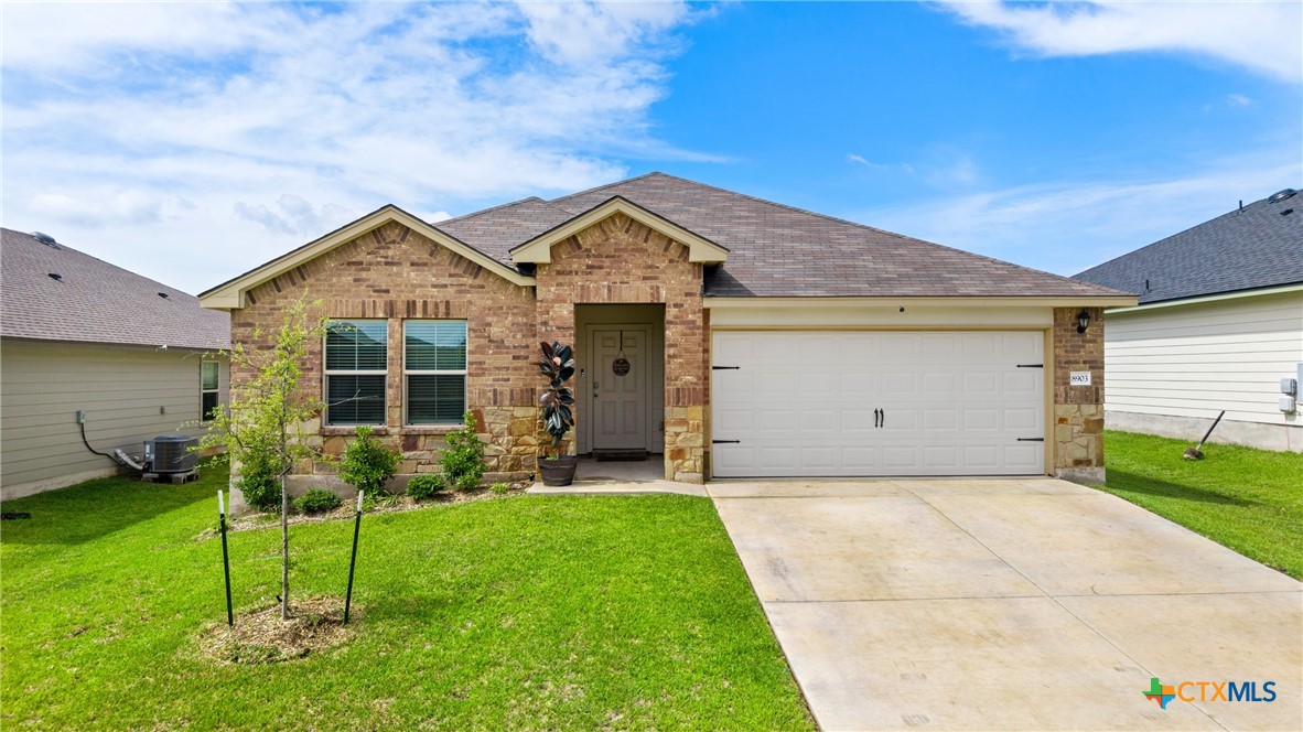 8903 Cantera Rdg Road Temple, TX 76502 - Photo 1 of 25 a front view of a house with a yard and garage